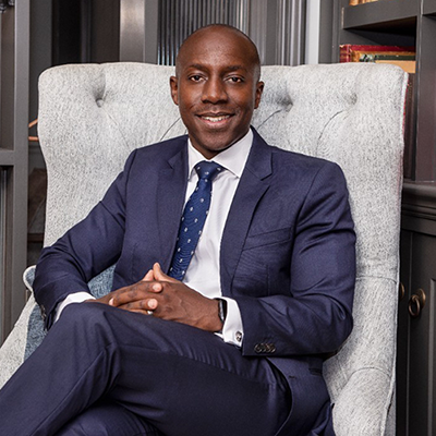 Photo of James Mnyupe sitting in a chair