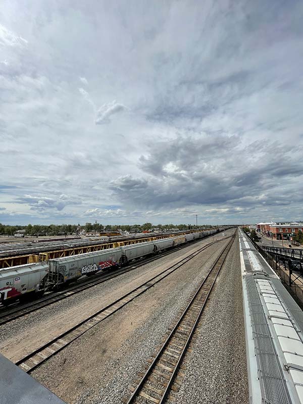 Railroad tracks under a cloudy sky