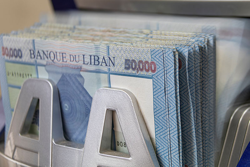 Lebanese Lira Currency being counted by a money counting machine