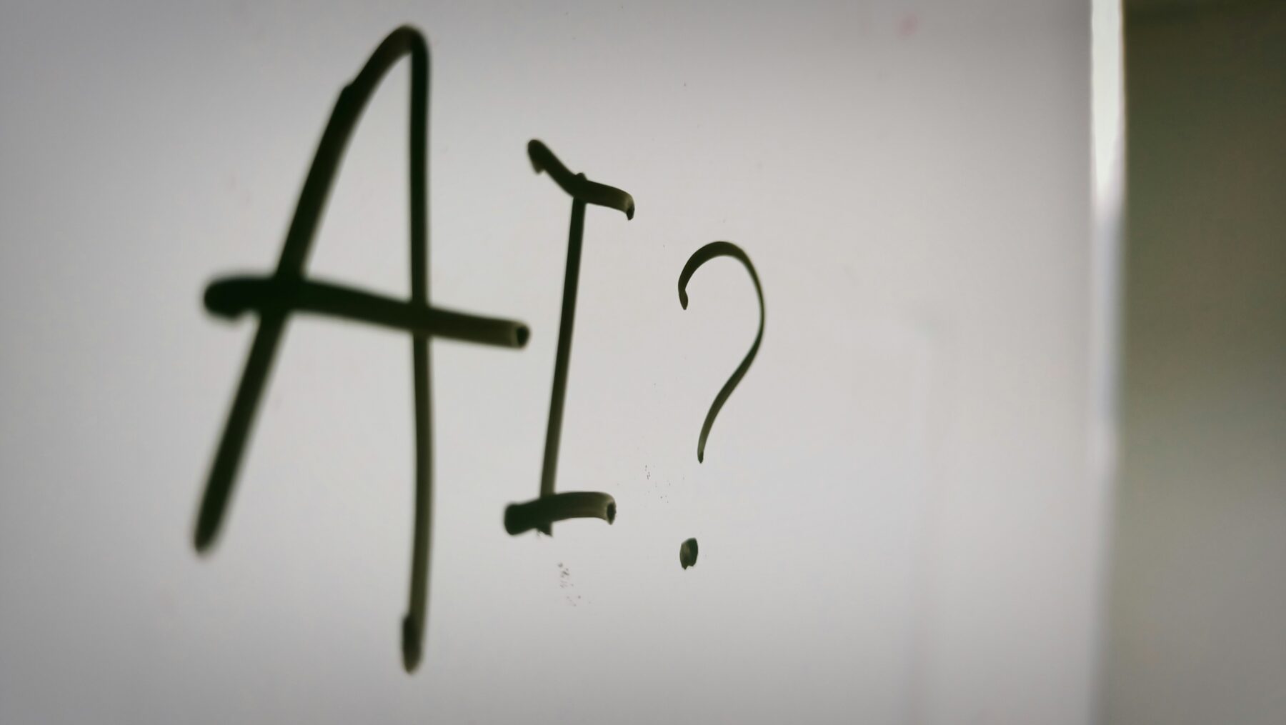 The word "AI" written on whiteboard.